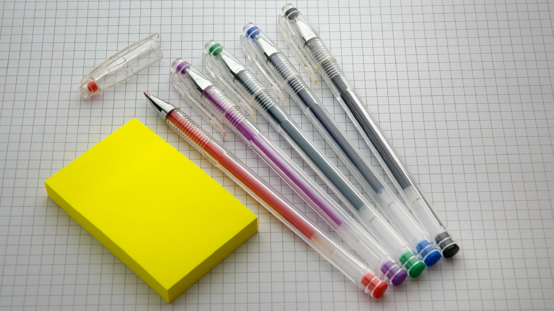 pens on paper with sticky notes